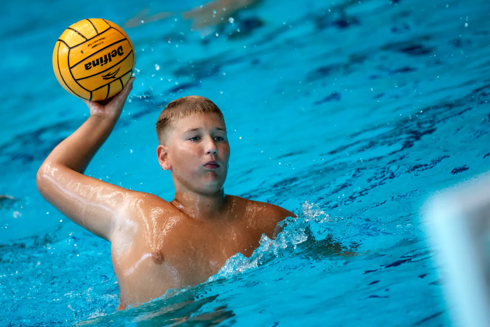 Young player lining up a shot in the pool at Tezoro Camp
