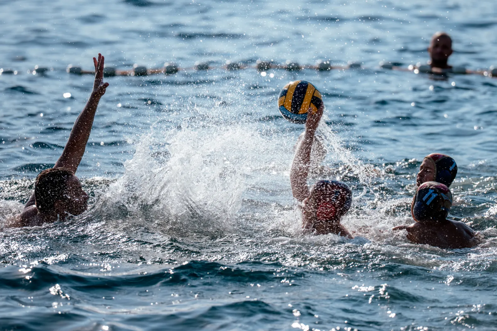 Shot on goal in open water with spray flying